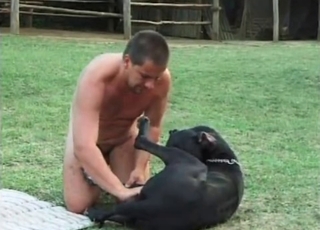 Naked male zoofil plays with his doggy