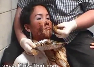 Asian girl is grinning as she eats fresh poop